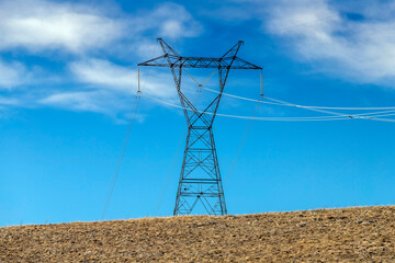 High voltage electric pole and transmission lines. High voltage grid tower with wire cable at...