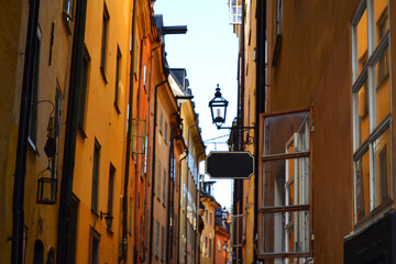 Fototapeta na wymiar Narrow street with colorful buildings in the Old Town (Gamla Stan), Stockholm center, Sweden