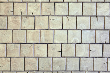 Wooden brick wall. Natural wood texture of square shape. Mosaic of bars. Vintage, abstract pattern. Old retro floor. Dark surface of squares. Rustic style.