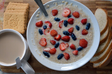 Oatmeal with berries. Fruit healthy natural diet breakfast.