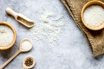 Obraz na płótnie Canvas rice for paella on stone background top view mock up