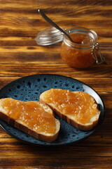 Two jam sandwiches on a blue plate.