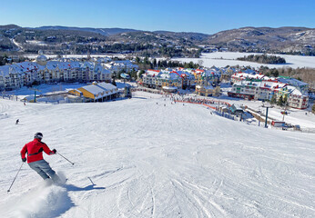Naklejka premium Skier on Mont Tremblant village resort in winter, Quebec, Canada