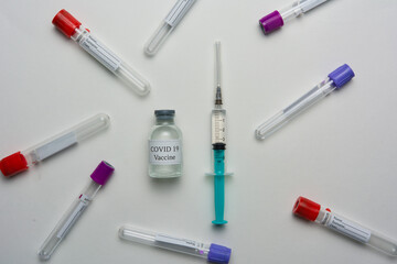 Covid 19 vaccine bottle and syringe on a white background.