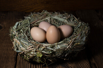 Easter eggs in a basket on a vintage wooden background. eggs in the nest with copy space