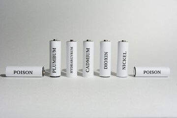 Battery on a white background. Ecology. Harm to nature from batteries.