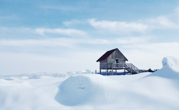 Little wooden cottage on a snow-covered field captured in Kulakkaya Plateau, Giresun, Turkey