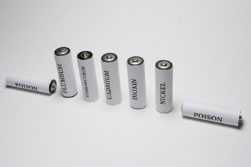 Battery on a white background. Ecology. Harm to nature from batteries.