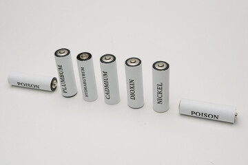 Battery on a white background. Ecology. Harm to nature from batteries.