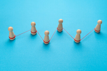 Human figures are embedded in a chain with a link. Social communications.