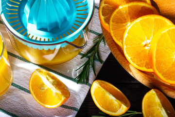 The process of making orange juice. Orange slices and juicer