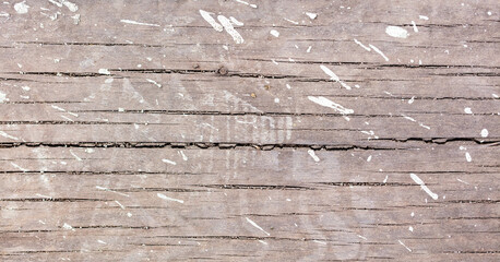 Drops and splashes from concrete on a wooden board
