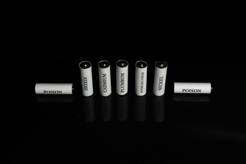 Battery on a black background. Ecology. Harm to nature from batteries.