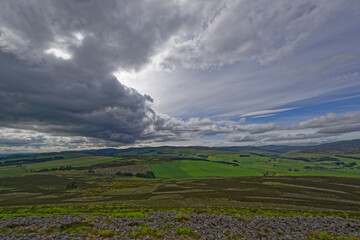 Fototapeta premium Looking North West over the remains of the stone ramparts of the White Caterthun to Glen Esk and the Angus Glens in the distance.