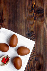 Easter chocolate eggs top view on wooden background mock up