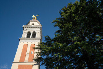 Fototapeta na wymiar The castle bell tower with the golden angel on the top