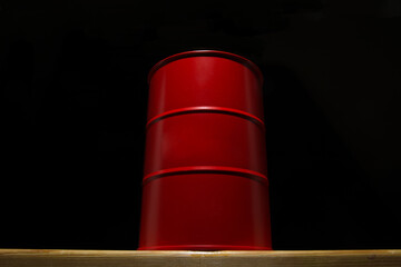 Red barrel of oil on a black background.