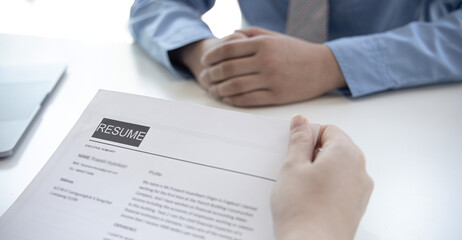 Obraz premium Employer or selection committee is reading the candidate's resume and competence background, Job interview by HR, History exam and work ability, Employment and Recruitment Concept...