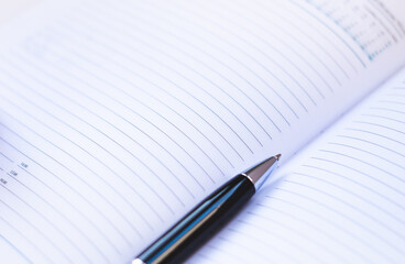 notebook and pen on the table