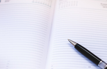 notebook and pen on the table