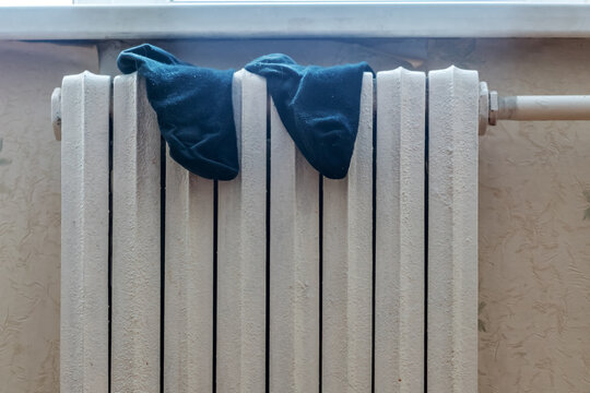 Dirty Wet Black Socks Men Hang And Wither On Cast Iron Radiator