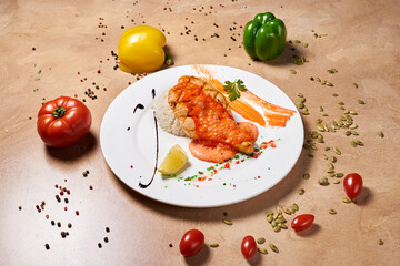 fish steak with rice drizzled with sauce