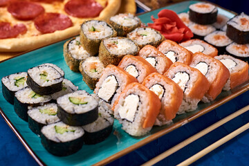 japanese rolls, sushi with sauce on a blue background