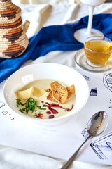 soup with cheese, dandelion leaves and crackers