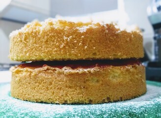 Victoria Cake traditional British dessert.. This fluffy sponge offering features a cream and jam core and is completed with a sprinkle of icing sugar.
