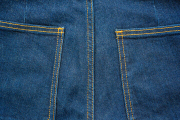 Fototapeta premium Backside denim blue jeans pocket closeup. Denim jeans texture. Blue jeans texture with pocket for any background. High quality photo