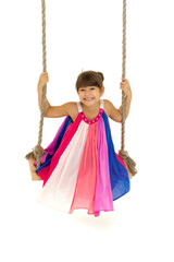 Cute girl having fun on wooden swing