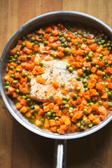 Fried salmon fish with carrot and peas 