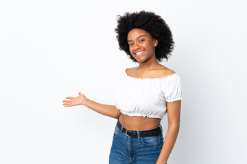 Young African American woman isolated on white background extending hands to the side for inviting to come