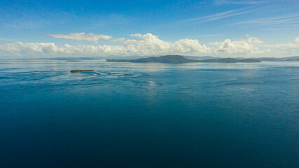 Seascape with blue sea and Islands.Sea against a blue sky with clouds. Mindanao, Philippines.
