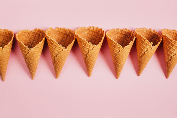 top view of empty waffle ice cream cups on pink background