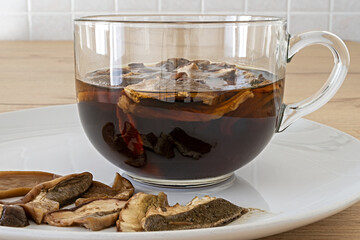 piatto e tazza di vetro con funghi porcini secchi in ammollo vista fronte altra vista