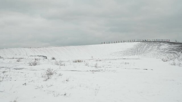 [4k] panning shot on top of halde haniel hill in Bottrop, Germany covered in snow