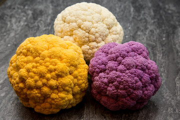Purple, Gold and White Cauliflower on a slate surface