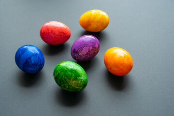 Easter eggs in a modern, colorful pattern on a black background. Selective focus.