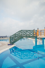 Large pool with clear blue water and relaxation areas. Swimming area on the territory of the hotel.