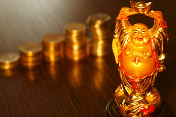 A Buddha figure and a stack of coins on the table.