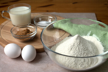 The necessary set of ingredients for making pancakes and pancakes eggs flour salt sugar and milk.