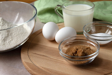The necessary set of ingredients for making pancakes and pancakes eggs flour salt sugar and milk.