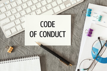CODE OF CONDUCT is written in a document on the office desk