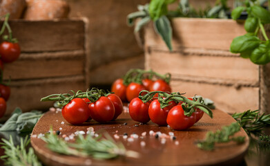 Red cherry tomatoes in a food photography scene with wood basket and details in background