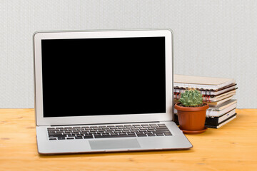 Fototapeta premium Notebook with notebooks and green succulent on a wooden table. mockup for text