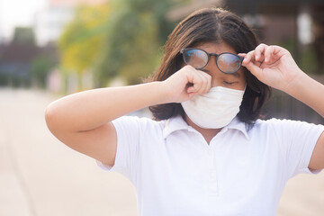Asian women are scratching their eyelids due to allergy outdoor  The Female has an itching eye. The...