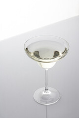 Vermouth in a cocktail glass on a gray background, slightly alcoholic drink