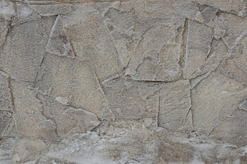 Irregular stone flags, frosted over, seen from above