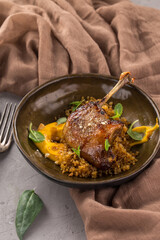 Duck confit Roasted duck leg with puree on brown plate on the table